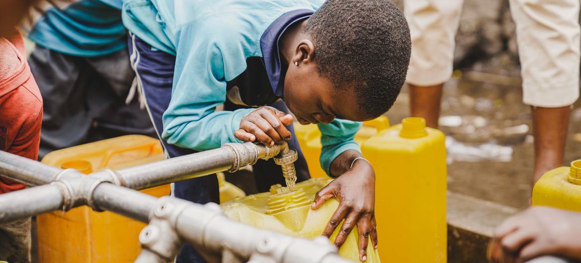 A child fills a container at a water tap installed by UNICEF in Kanyaruchinya near Goma, in the eastern DR Congo.