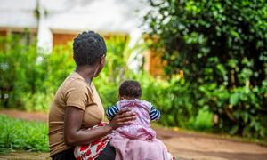 A 17-year-old survivor of rape sits with her baby in the eastern DR Congo.