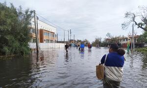 Residents of Toamasina wade through flooded streets after Cyclone Gezani hit Madagascar on February 10, disrupting infrastructure and cutting off access to essential services. WFP teams are working to deliver aid to affected communities.