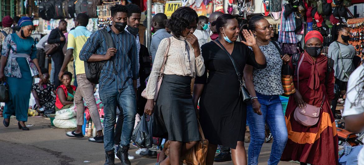 People walk through a shopping district in Kamapla, Uganda, during the COVID pandemic.