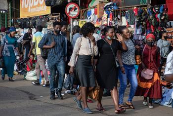 People walk through a shopping district in Kamapla, Uganda, during the COVID pandemic.