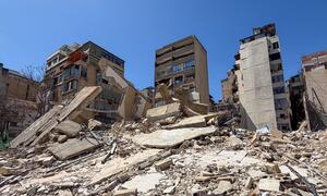 Destroyed residential buildings in the Basta neighborhood of Beirut, Lebanon, showing widespread rubble and debris following Israeli airstrikes.