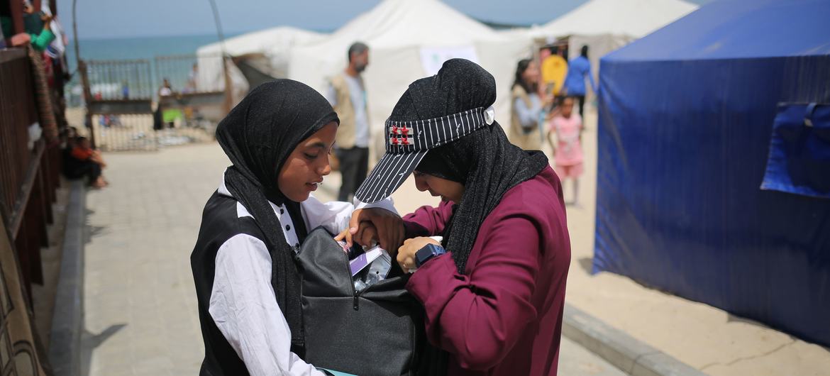 Girls affected by the ongoing conflict in Gaza receive a care and protection package distributed by UNICEF.
