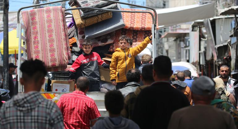 Two children stand at the back of a truck as their family flees Rafah in the south of the Gaza Strip.