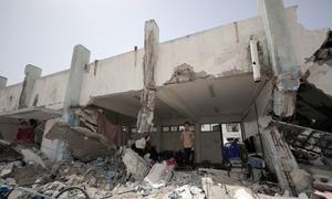 A bombed-out school provides some shelter to a family in Khan Younis, Gaza. 