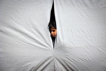Um menino olha de dentro de uma tenda em Rafah, no sul da Faixa de Gaza
