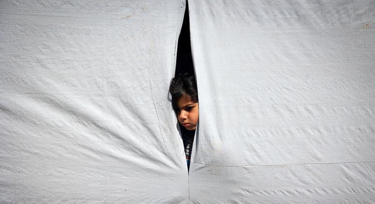A young boy looks out from inside a tent in Rafah, in the southern Gaza Strip.