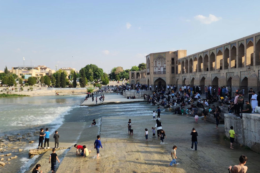 Children play by a river in Tehran. (file)