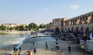 Children play by a river in Tehran. (file)
