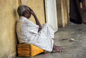 An elderly woman sits on a jerry can in the Haitian capital, Port-au-Prince.