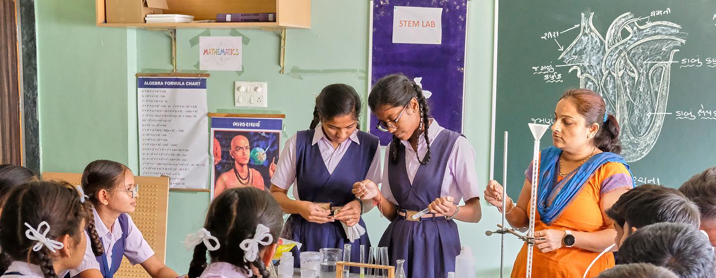 Girls study science at a school in India.