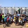 Children and their families fetching water from a UNICEF-supported water tank in Deir Al-Balah in the Gaza Strip.