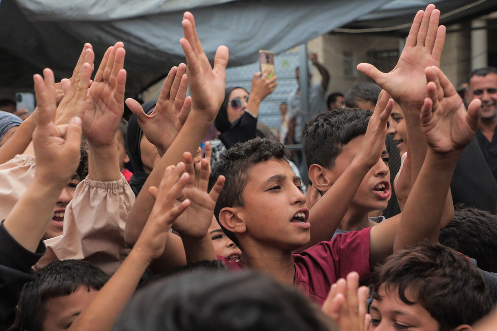 À Gaza, des enfants lèvent les mains et applaudissent pour célébrer l'annonce d'un cessez-le-feu.