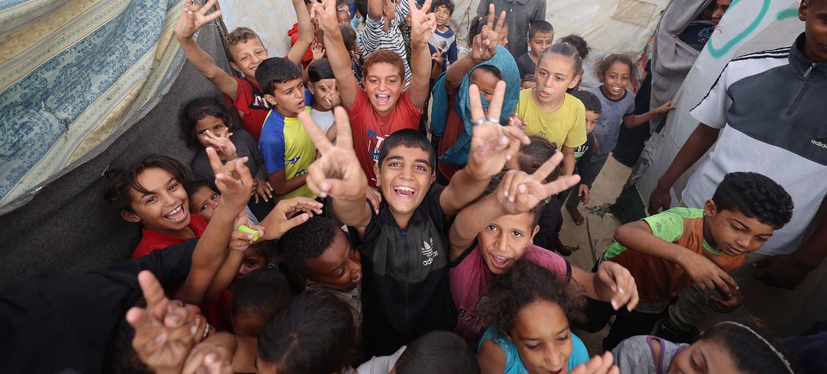 Children in Gaza celebrate the announcement of a ceasefire in October 2025.