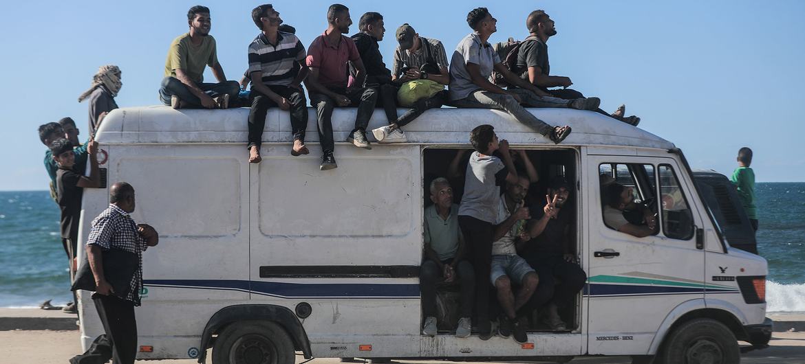 Displaced Palestinians travel along the coastal road back to northern Gaza. Displaced Palestinians travel along the coastal road back to northern Gaza.