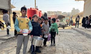 Children queue for hot food in Aleppo, Syria.