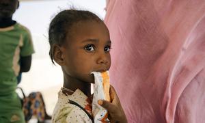 A child eating enriched porridge to prevent malnutrition, in a health center in Mauritania.