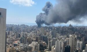 Smoke rises from a bombing in Beirut, Lebanon, seen from a high vantage point overlooking the city's dense urban landscape on April 8, 2026.