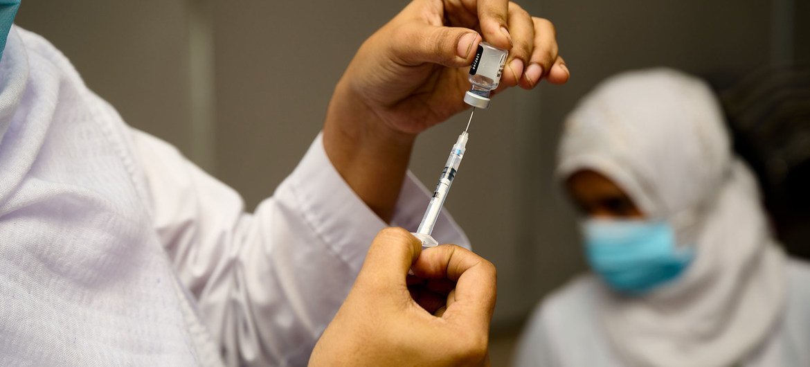 A vaccine is prepared at a COVAX vaccination launch in Dhaka, Bangladesh.