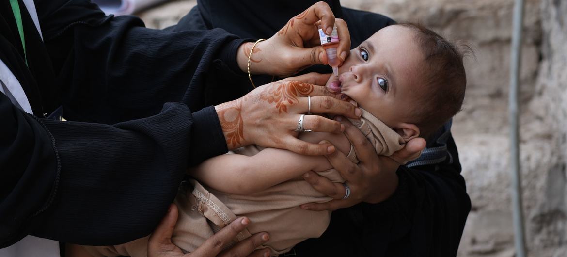 A child receives a polio vaccination in Yemen. A child receives a polio vaccination in Yemen.