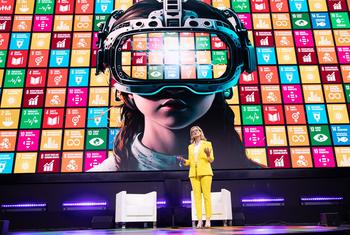 ITU Secretary-General Doreen Bogdan-Martin in a yellow suit speaks on stage at the AI for Good Global Summit in Geneva.