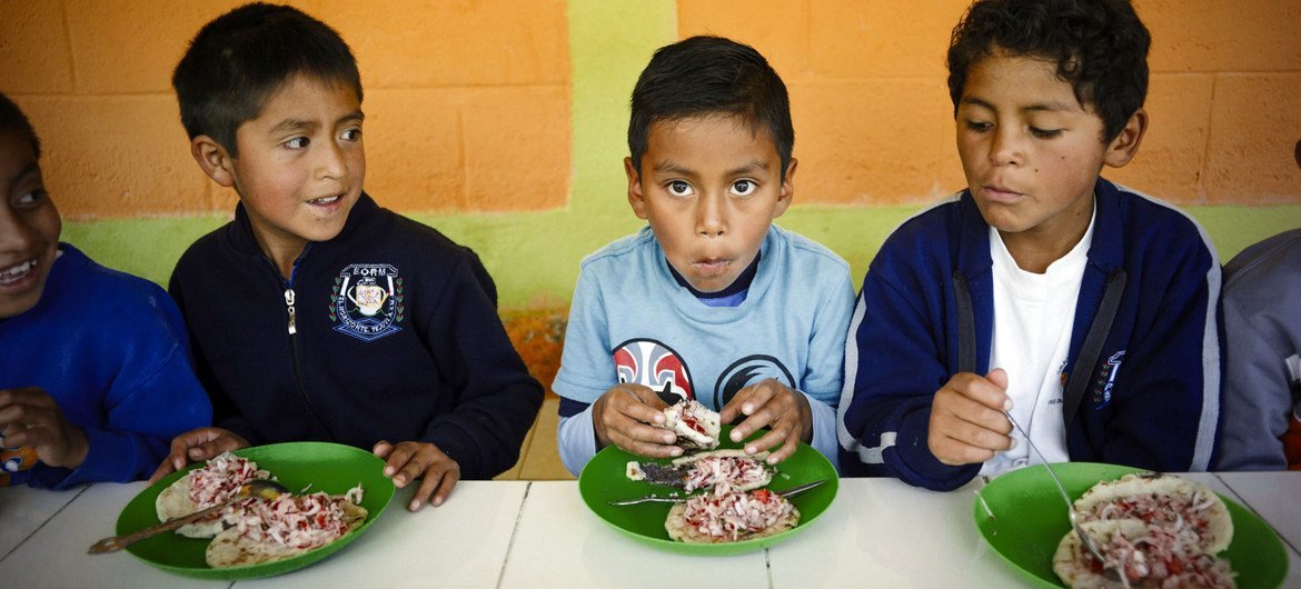 Schoolboys eat lunch at school in Guatemala.