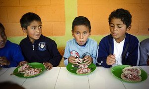 Schoolboys eat lunch at school in Guatemala.