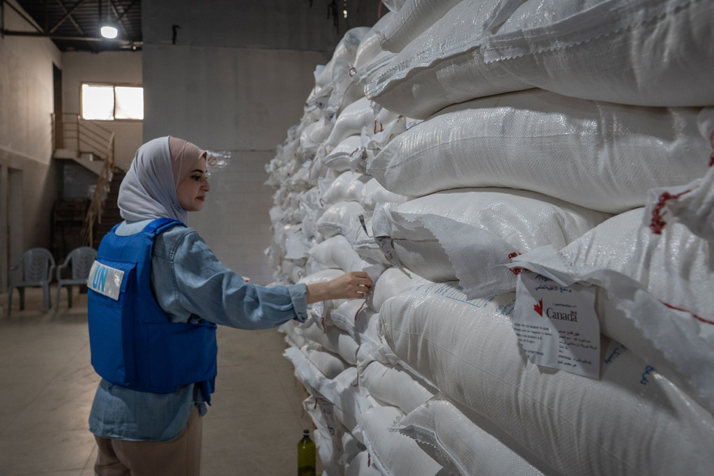 A UN worker checks food supplies in a warehouse in Nuseirat, Gaza.