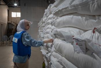 A UN worker checks food supplies in a warehouse in Nuseirat, Gaza.