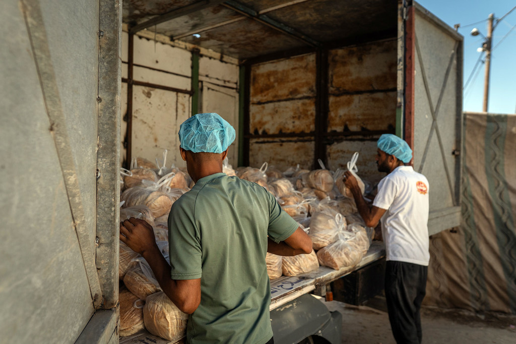 Bread is readied for distribution in Nuseirat, Gaza. Since the ceasefire took effect, flow of aid into the Strip has increased but needs remain immense.