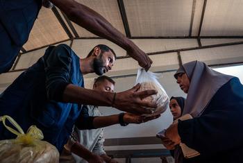 Bread is distributed at a bakery in Nuseirat, Gaza. Bread is distributed at a bakery in Nuseirat, Gaza.