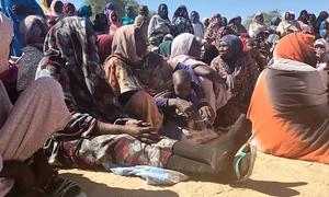 Displaced Sudanese people wait to receive food from the World Food Programme (WFP). (file)