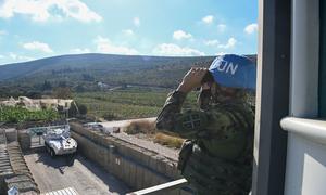 A UN peacekeeper looks out from a UNIFIL position in southern Lebanon.