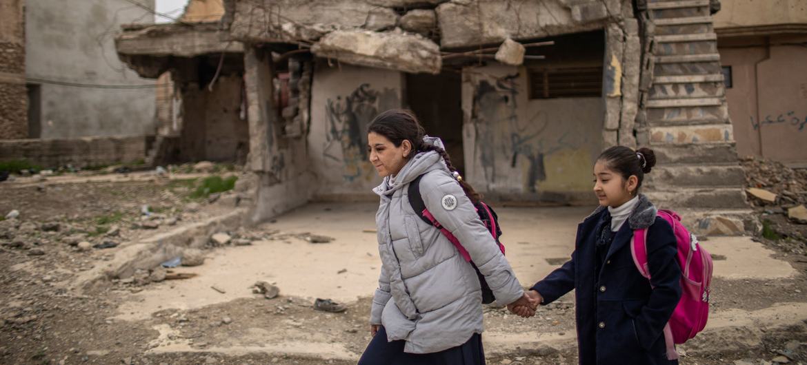 In the Old City of Mosul, Iraq, 15-year-old Noor (left) and her cousin Rahaf walk together to school.