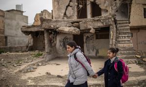 In the Old City of Mosul, Iraq, 15-year-old Noor (left) and her cousin Rahaf walk together to school.