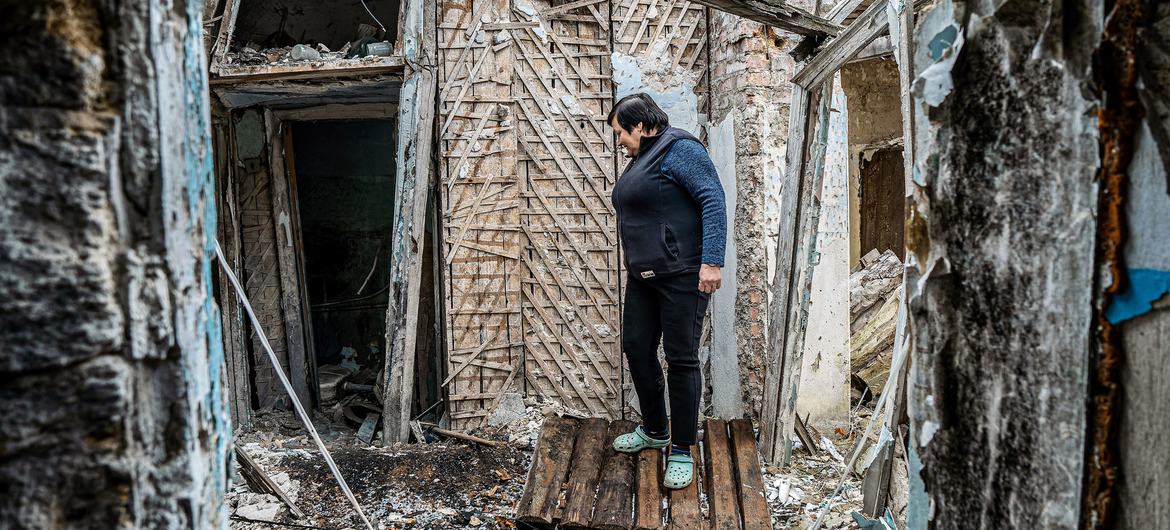 A woman stands in the ruins of her house in Mykolaiv in the south of Ukraine.