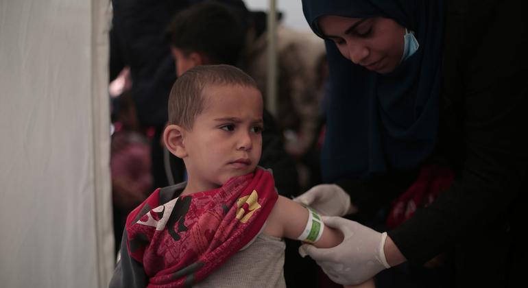 A three-year-old is screened for malnutrition at pediatrician clinic set up in a tent in Rafah, southern Gaza.