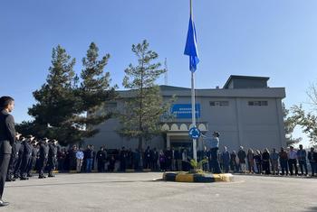 UN staff in Afghanistan observe a minute of silence as the UN flag is lowered to half-mast at the Mission Headquarters.