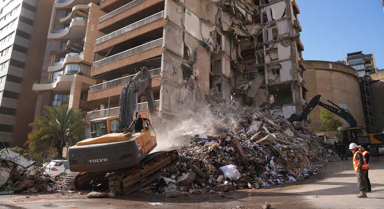 Спасатели ликвидируют последствия ракетного обстрела района в Бейруте.