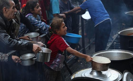 People plea for food at a communal kitchen in Gaza.