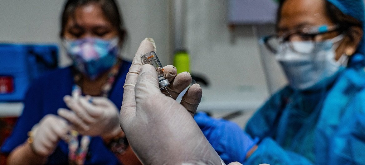 COVID-19 vaccinations are prepared at a vaccine access facility in the Philippines.