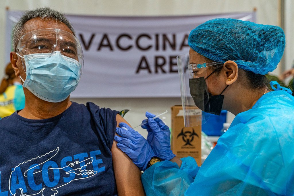 A nurse administers a COVID-19 vaccination.