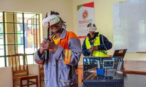 Young people learn gas welding techniques using virtual reality software.