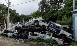 Scrapped police vehicles are piled up in the northern Haitian city, Cap Haitien.
