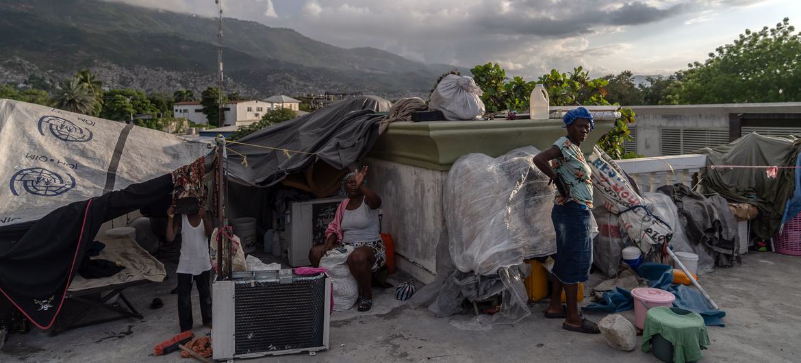 A family displaced by gang violence in  Port-au-Prince, Haiti, lives in a tent on the roof of a former government building.