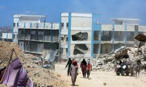 A school which had sheltered displaced people in Gaza stands in ruins.