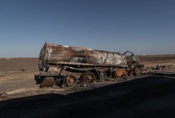 A burnt-out oil tanker rests on the road into Khartoum from Shendi, Sudan.