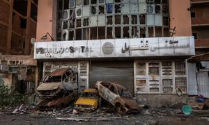 Burnt-out cars in Khartoum demonstrate how the conflict has affected life in Sudan.