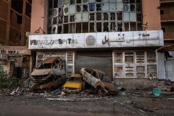 Burnt-out cars in Khartoum demonstrate how the conflict has affected life in Sudan.