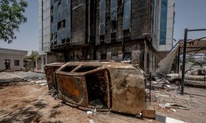 An upturned vehicle lies in front of a building in the Sudanese capital, Khartoum. (file) 